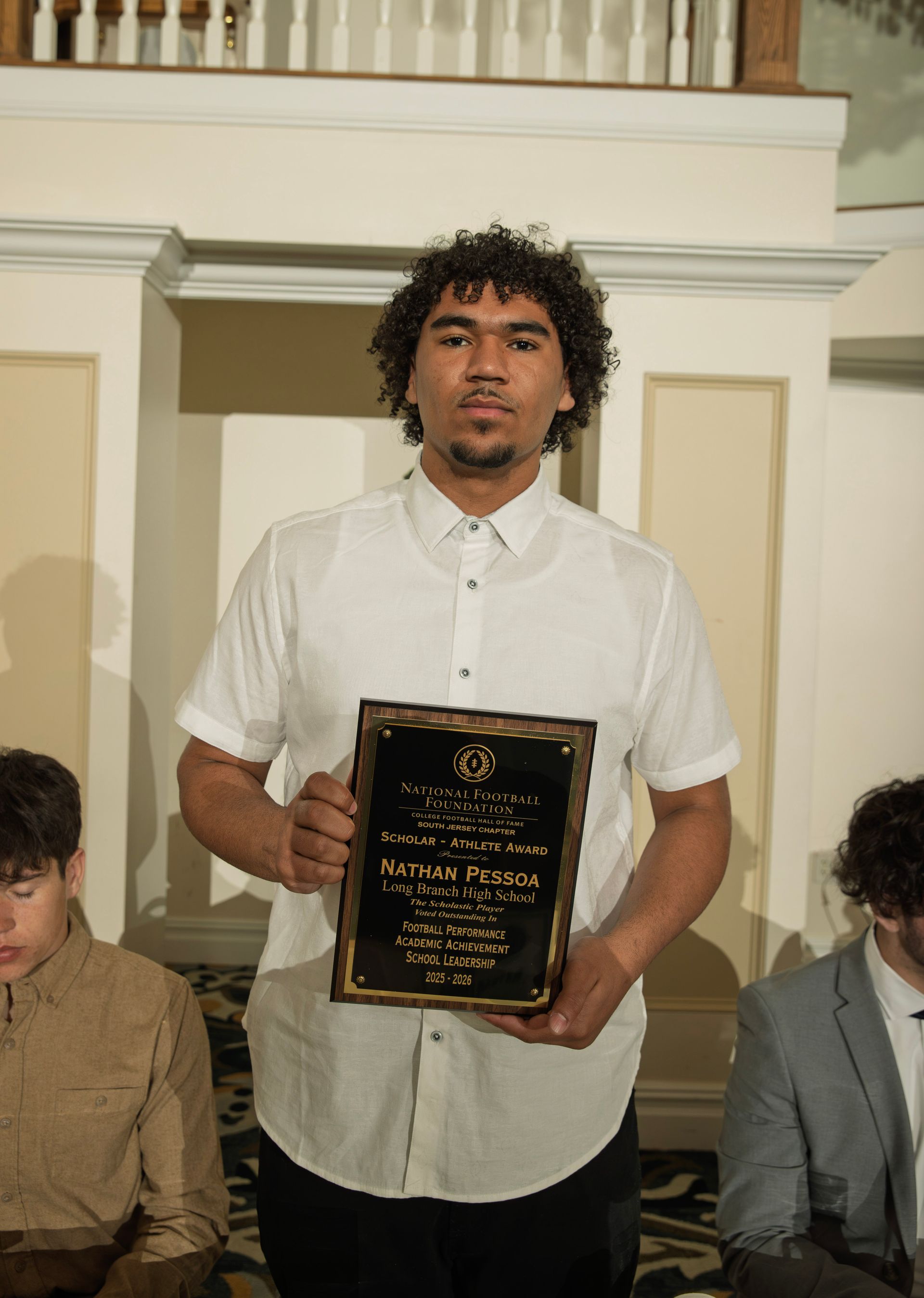Nathan Pessoa from Long Branch High School holding scholar-athlete awards plaque from NFFSJ