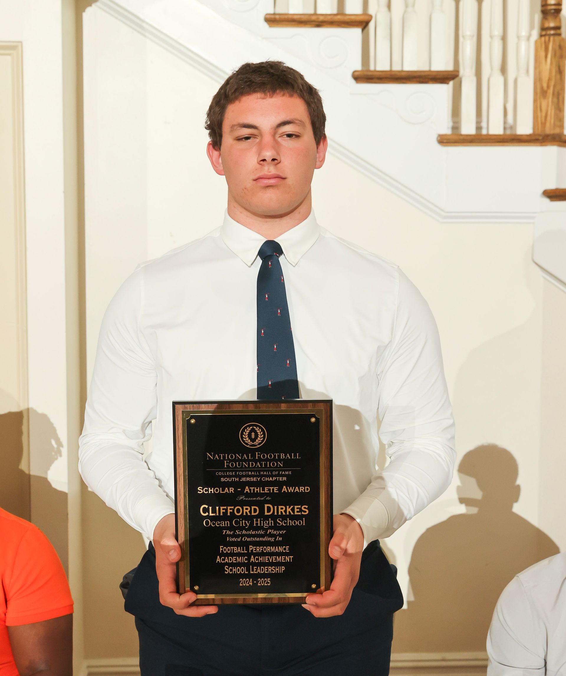 clifford dirkes of ocean city high school holding an awards plaque