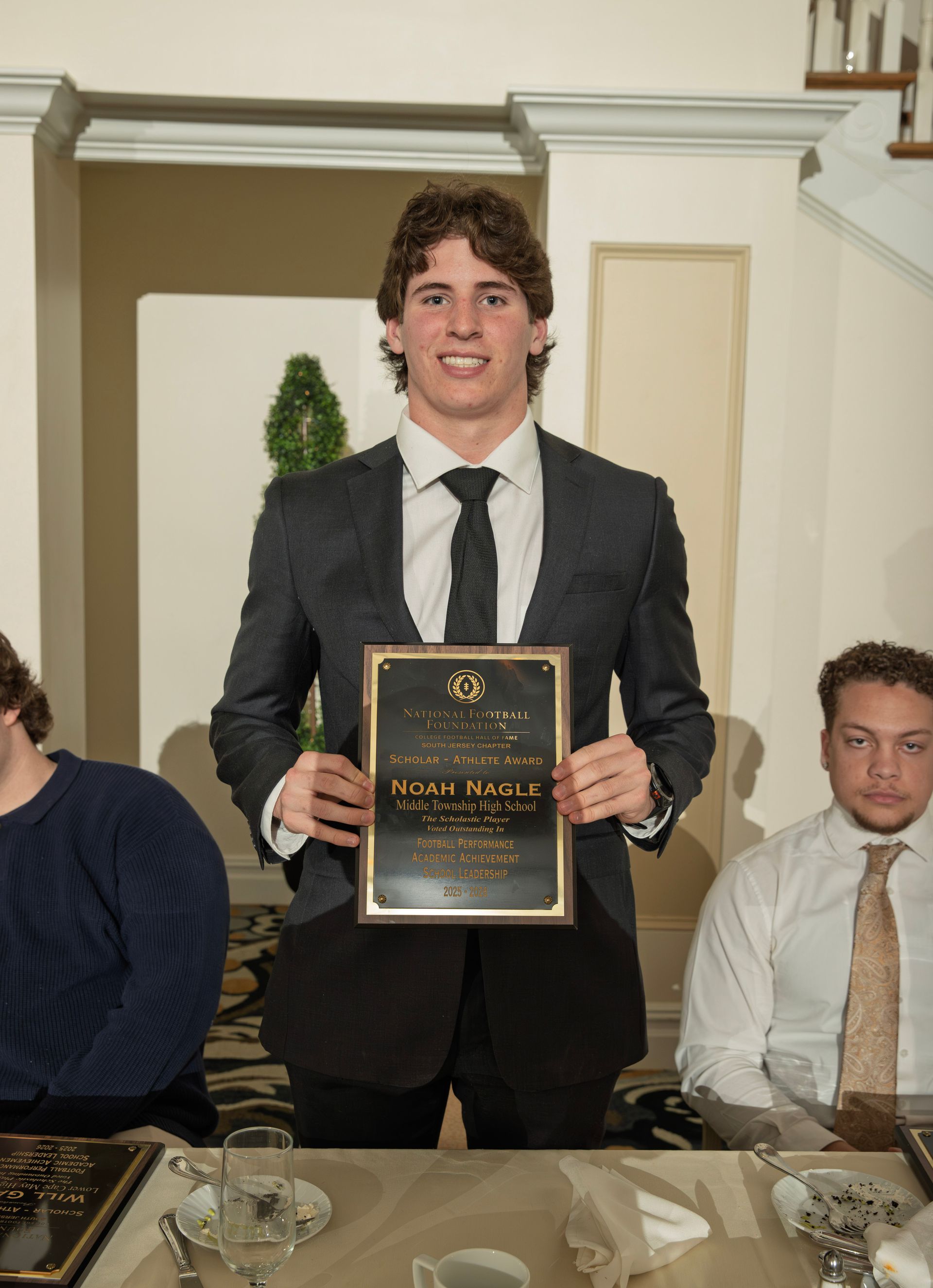 Noah Nagle from Middle Township High School holding scholar-athlete awards plaque from NFFSJ