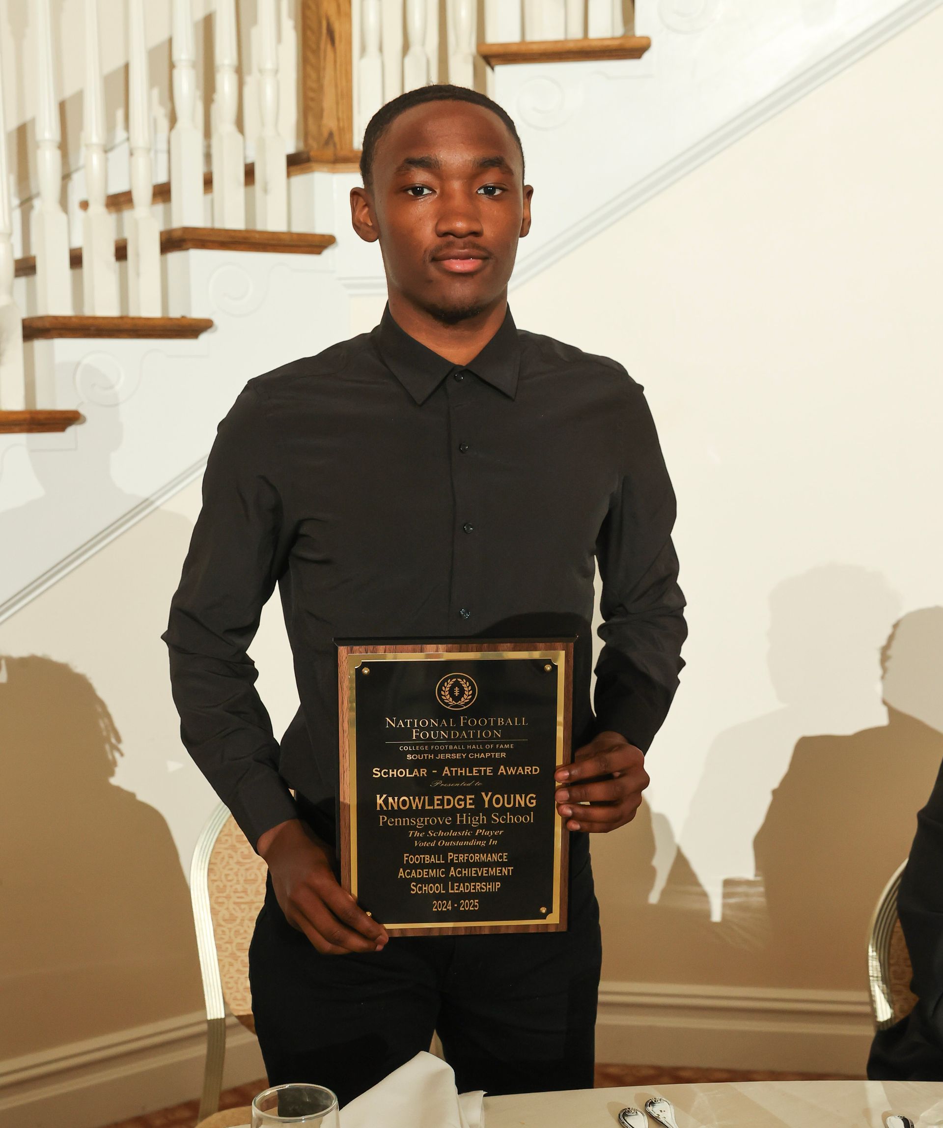 knowledge young of pennsgrove high school holding an awards plaque