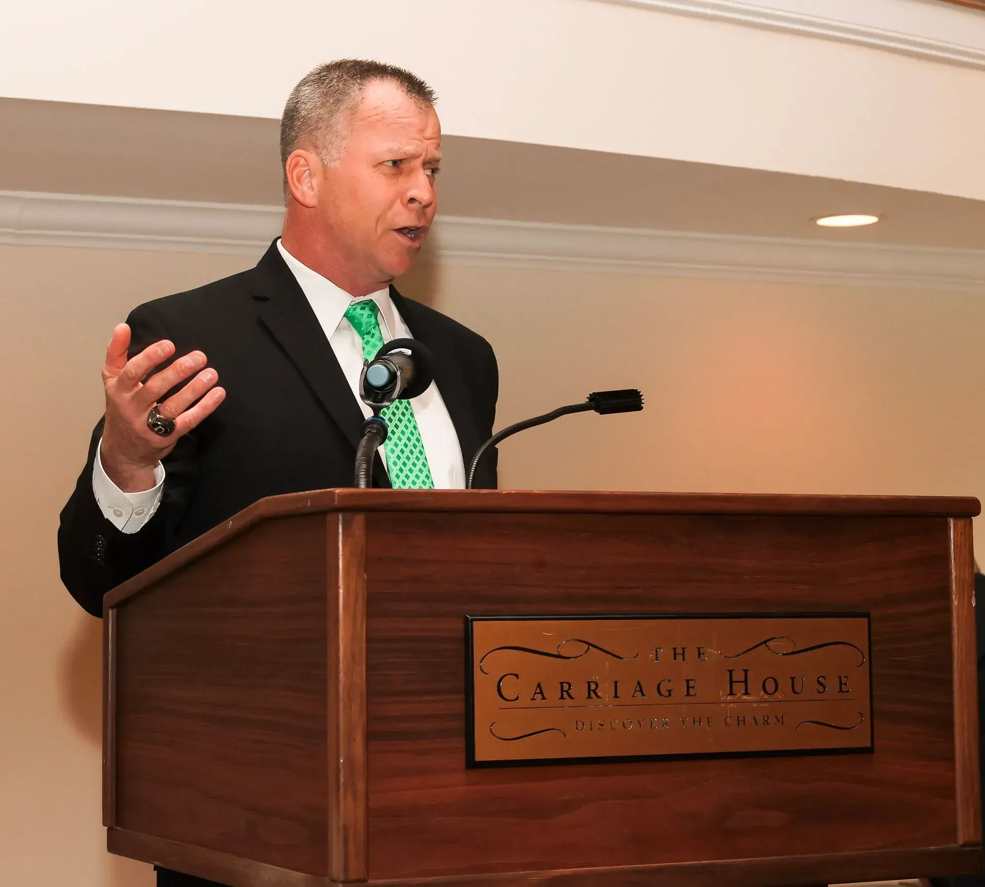 a man stands at a podium that says the carkage house