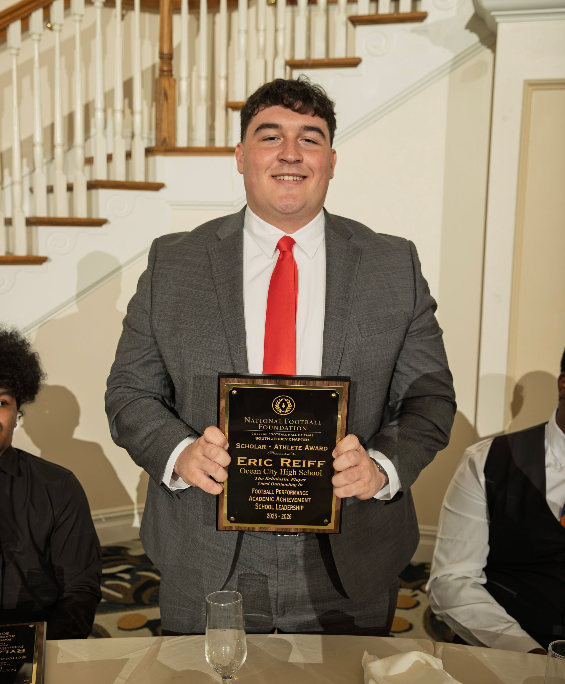 Eric Reiff from Ocean City High School holding scholar-athlete awards plaque from NFFSJ