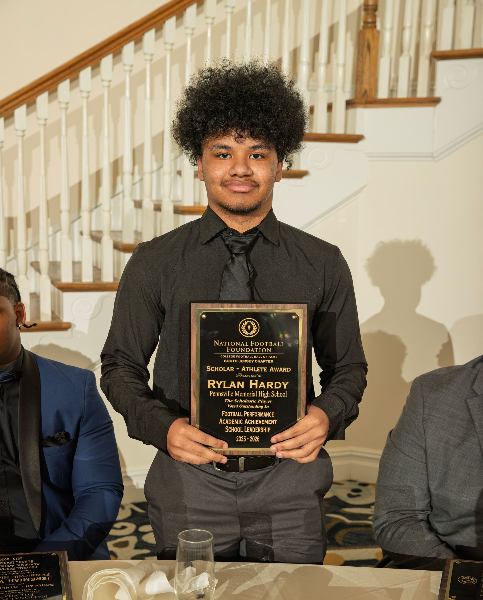 Rylan Hardy from Pennsville Memorial High School holding scholar-athlete awards plaque from NFFSJ