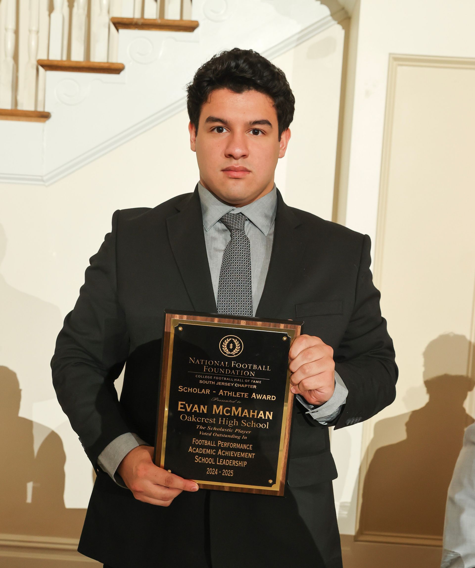 evan mcmahan of oakcrest high school holding an awards plaque