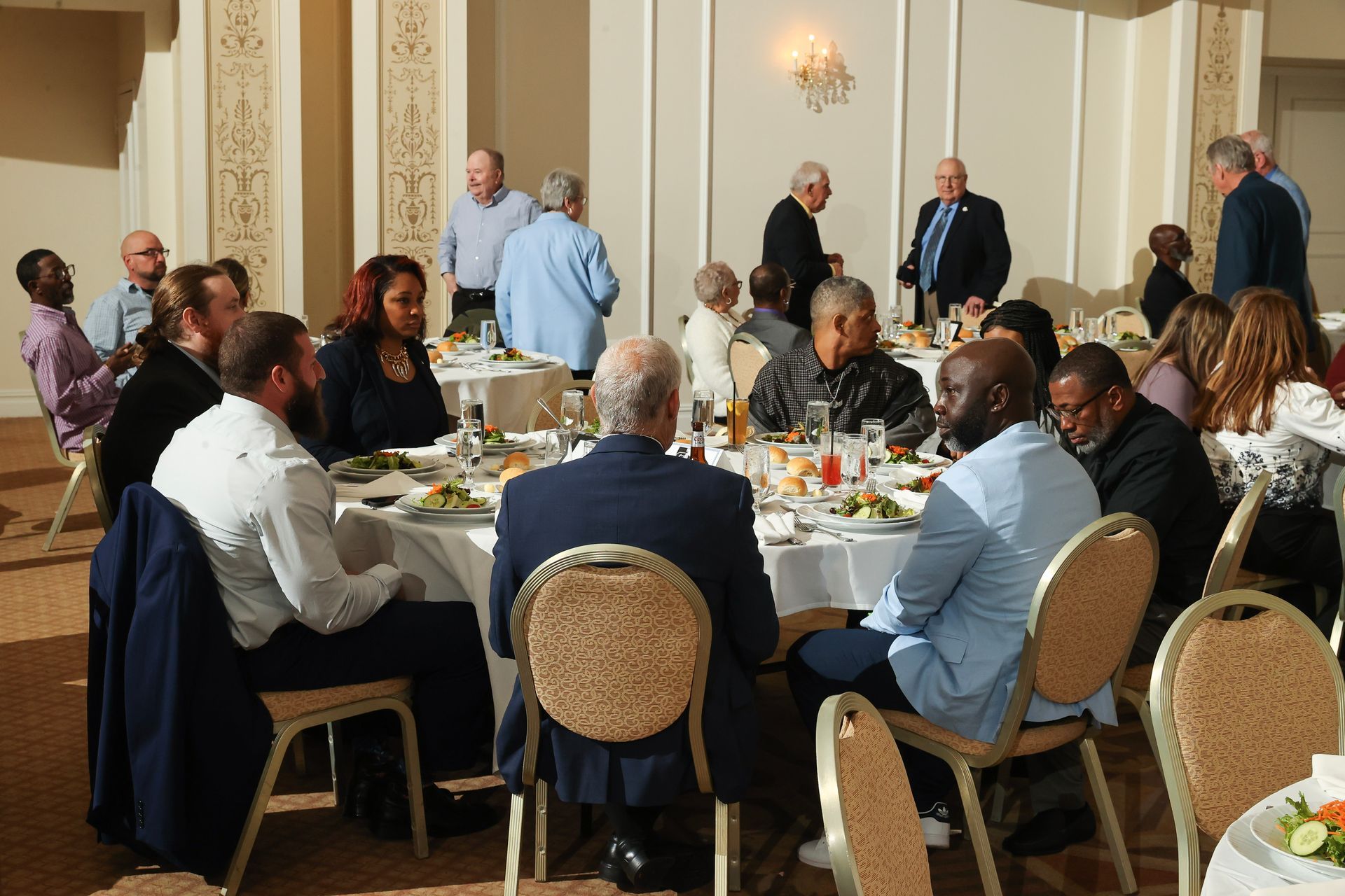 A group of people are sitting at tables in a room