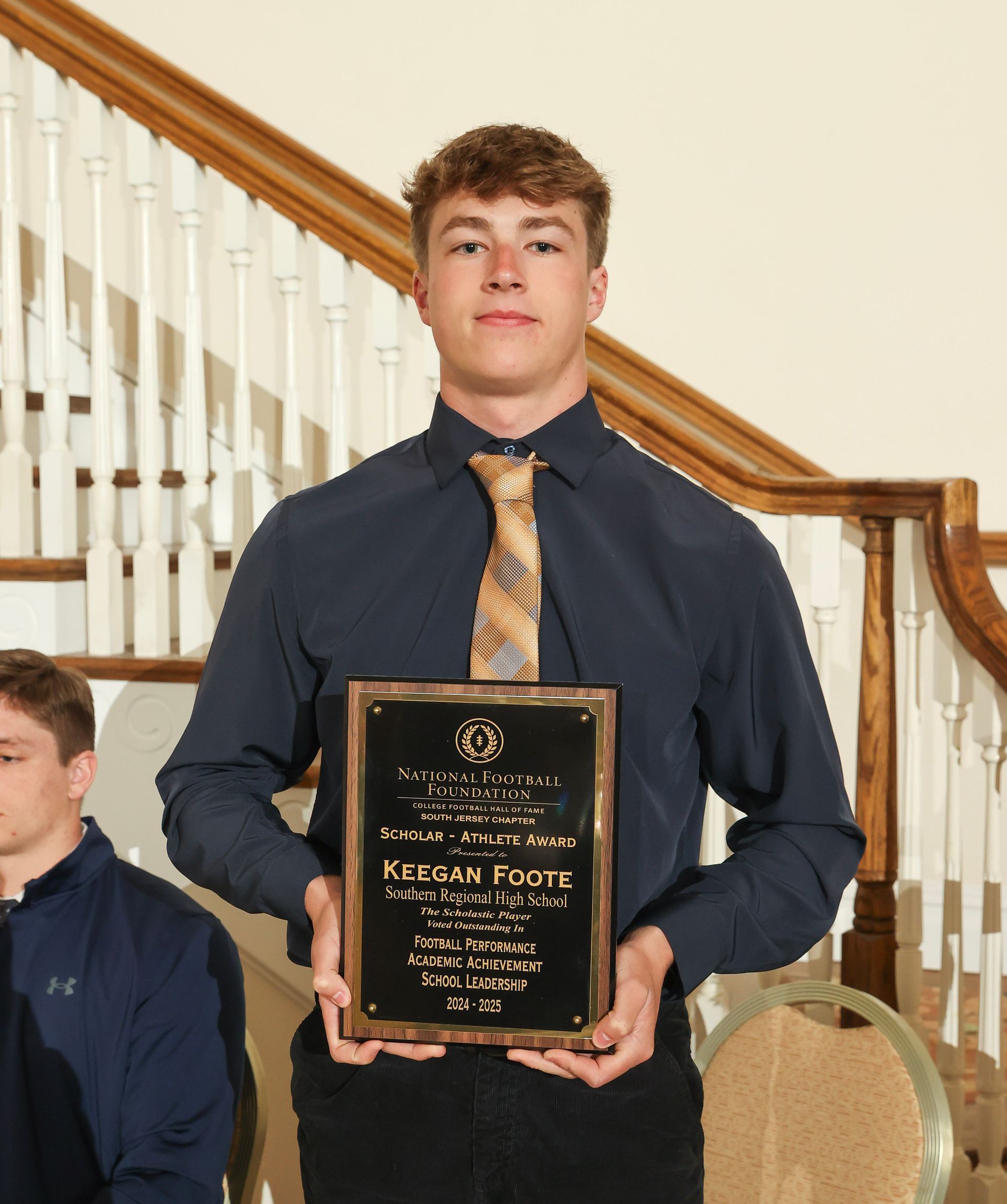 keegan foote of southern regional high school holding an awards plaque