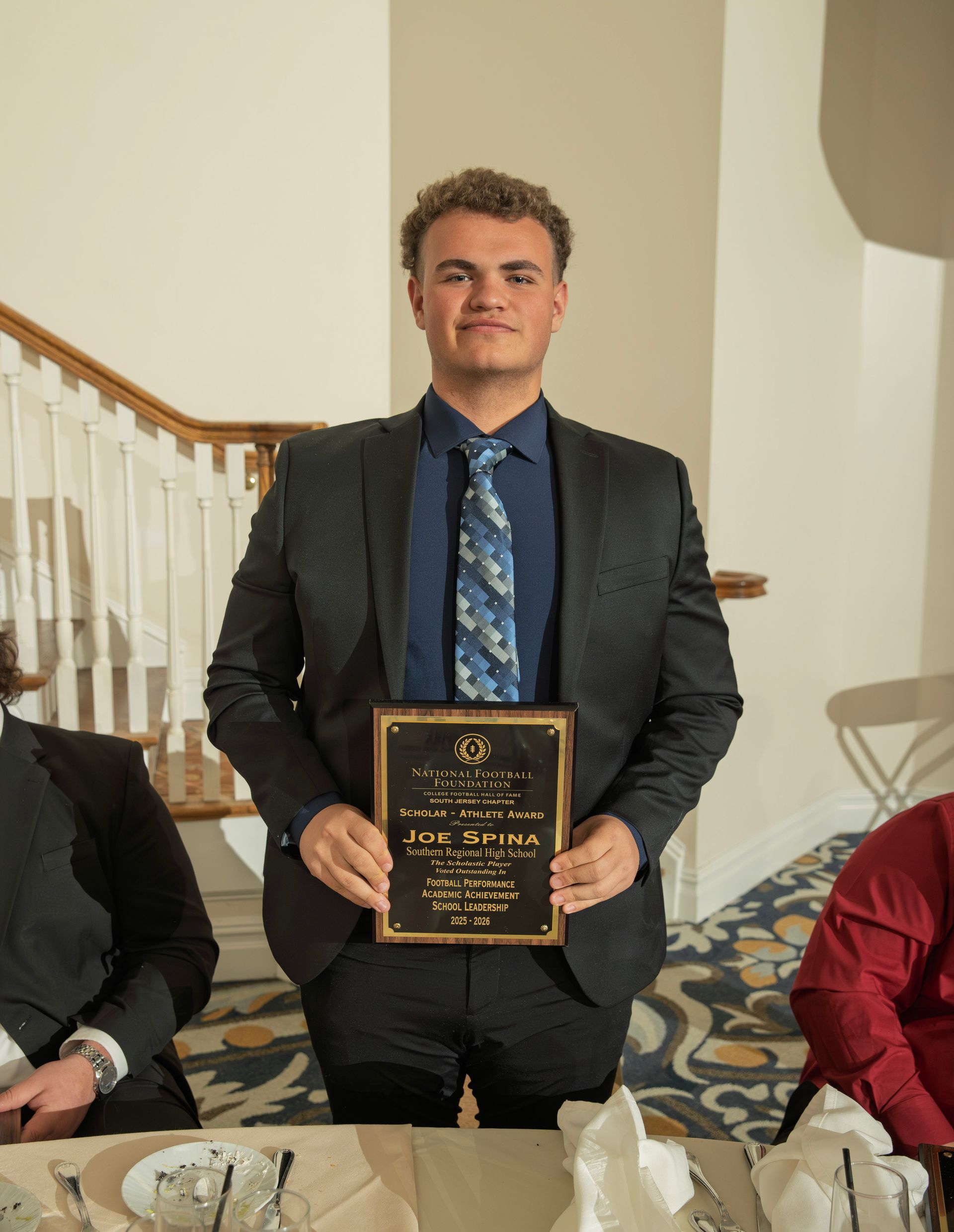 Joe Spina from South Regional High School holding scholar-athlete awards plaque from NFFSJ