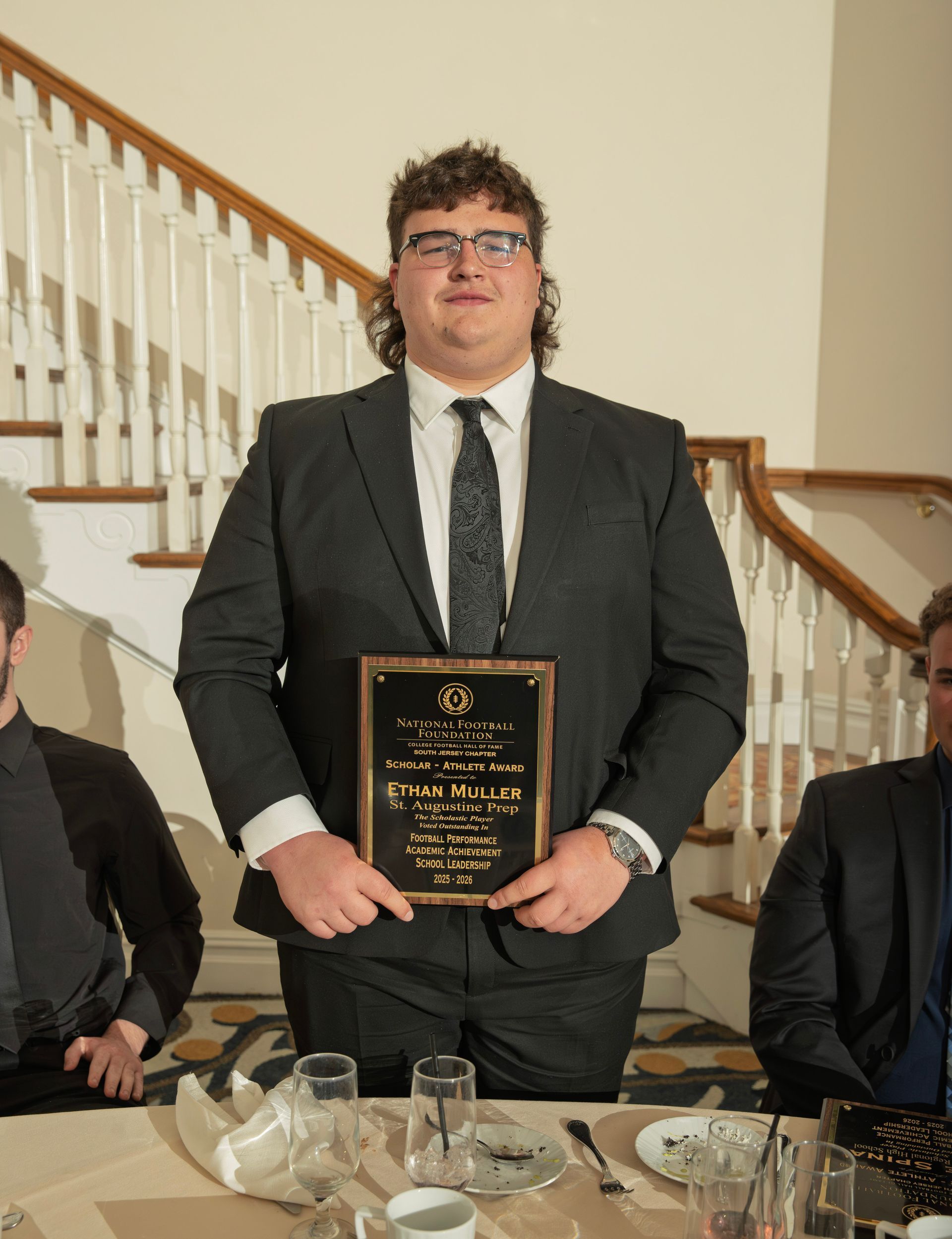 Ethan Muller from St. Augustine High School holding scholar-athlete awards plaque from NFFSJ