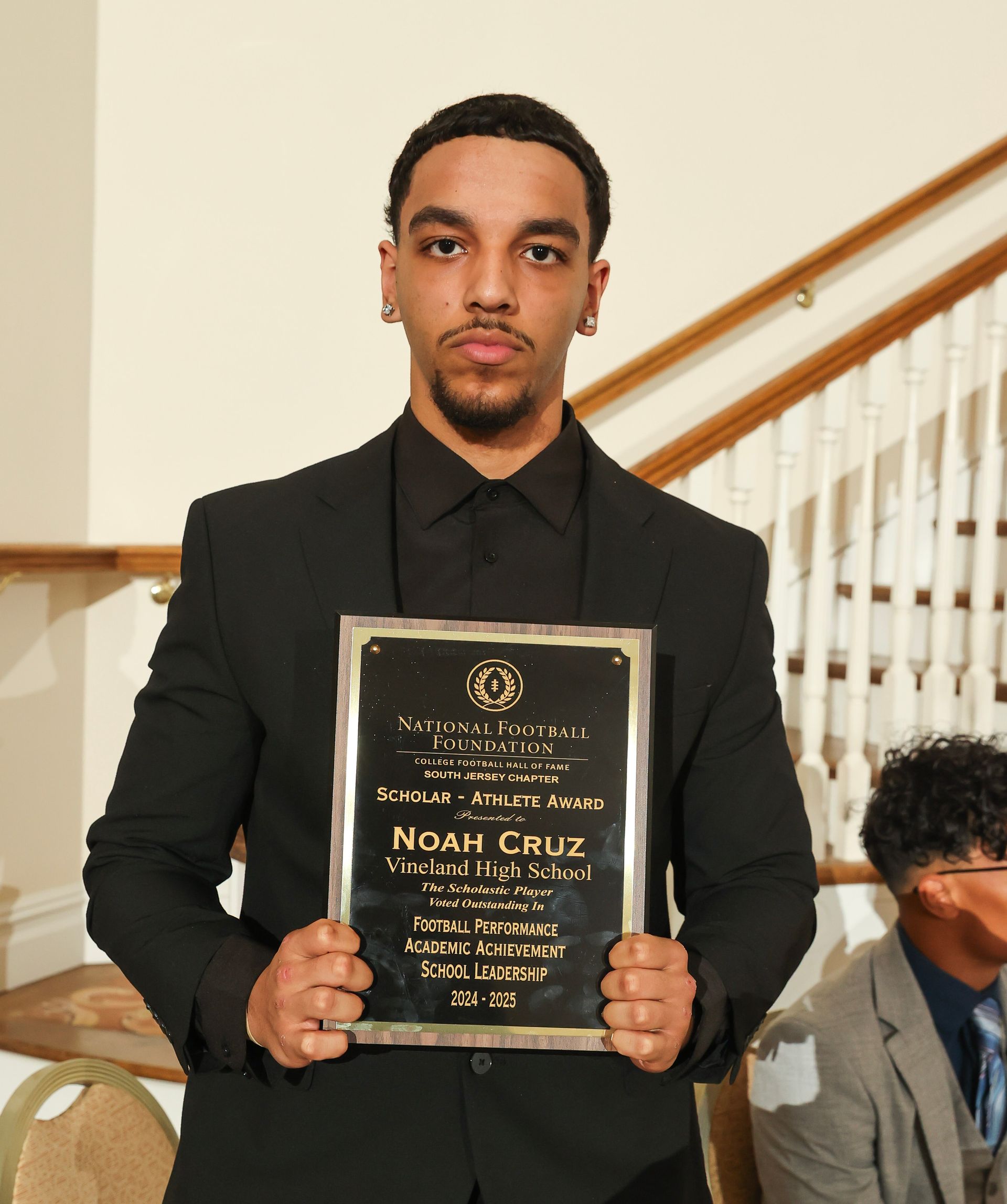 noah cruz of vineland high school holding an awards plaque