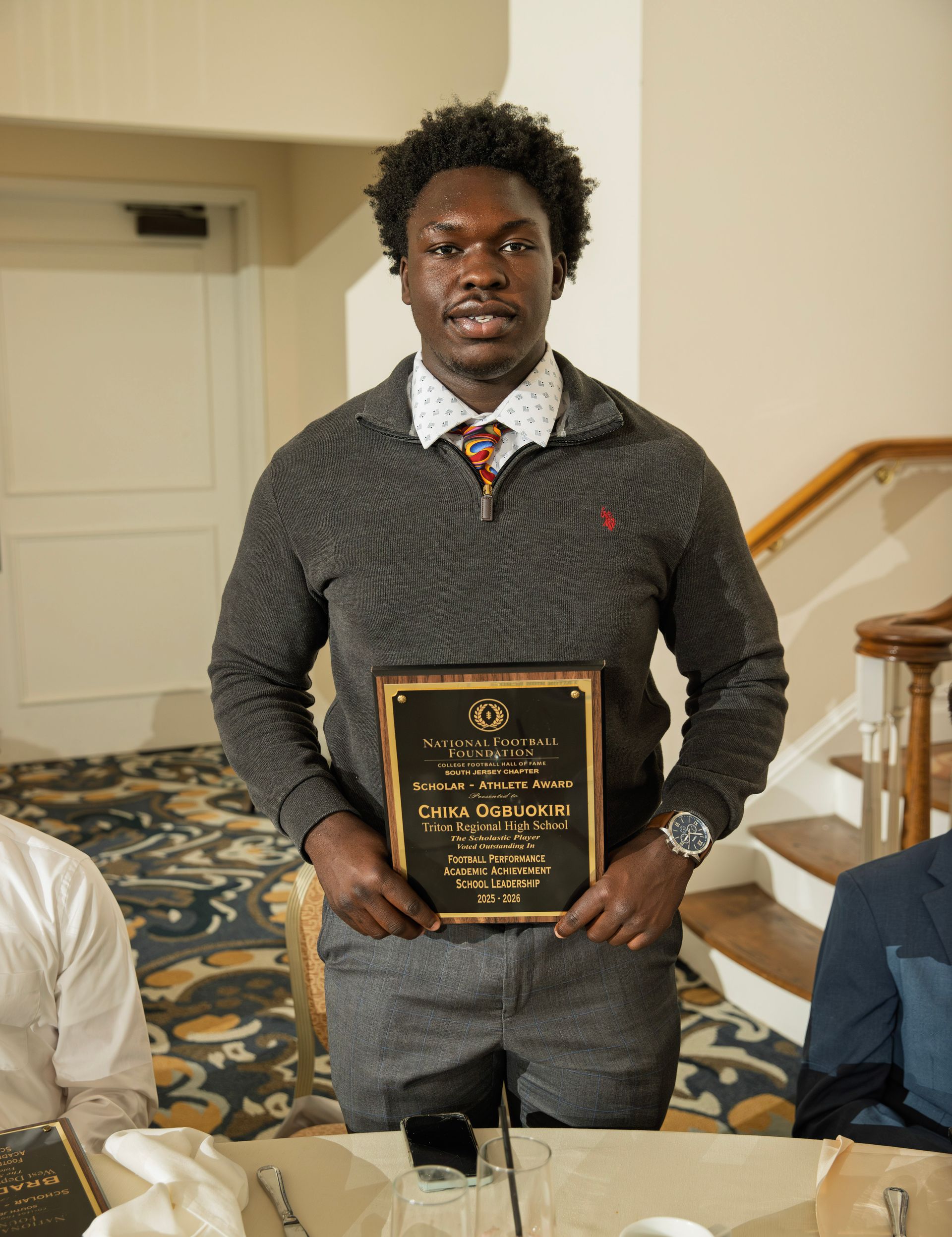 Chika Ogbuokiri from Triton Regional High School holding scholar-athlete awards plaque from NFFSJ