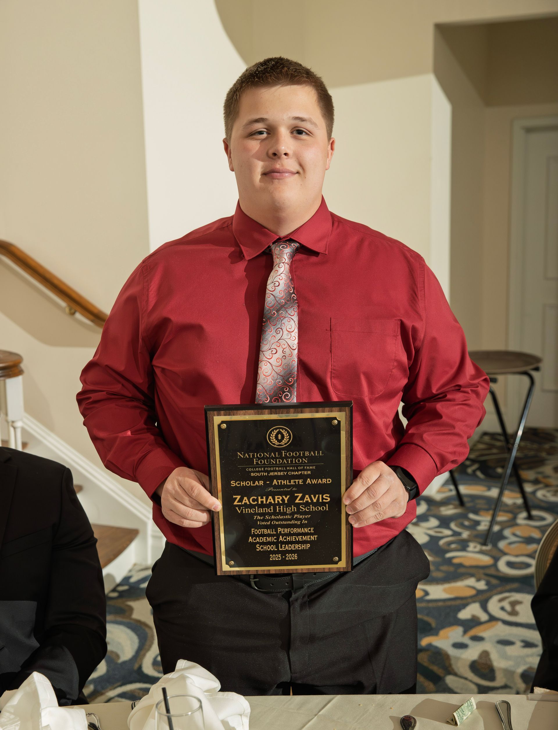 Zachary Zavis from Vineland High School holding scholar-athlete awards plaque from NFFSJ