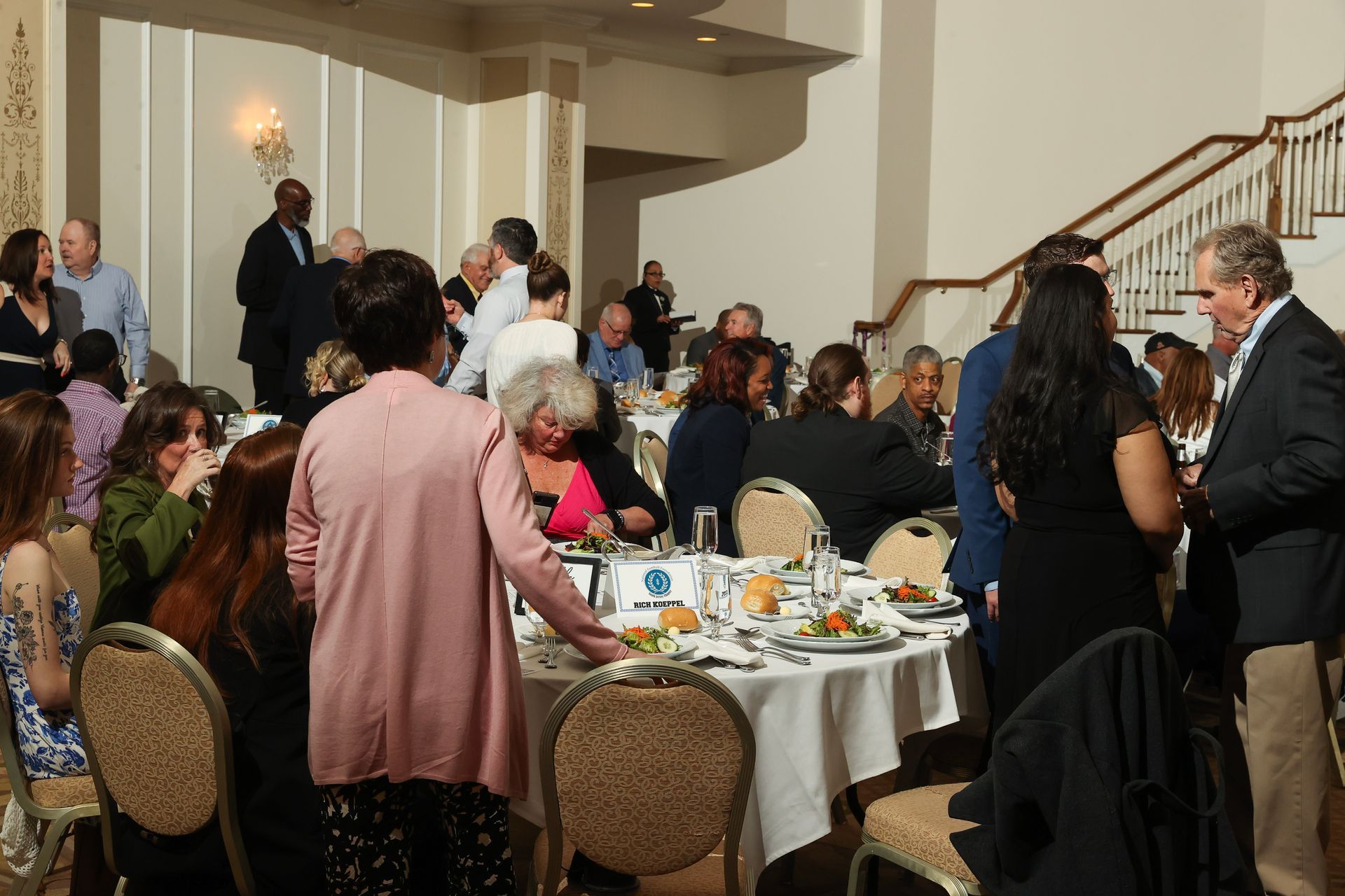 A large group of people are sitting at tables in a room