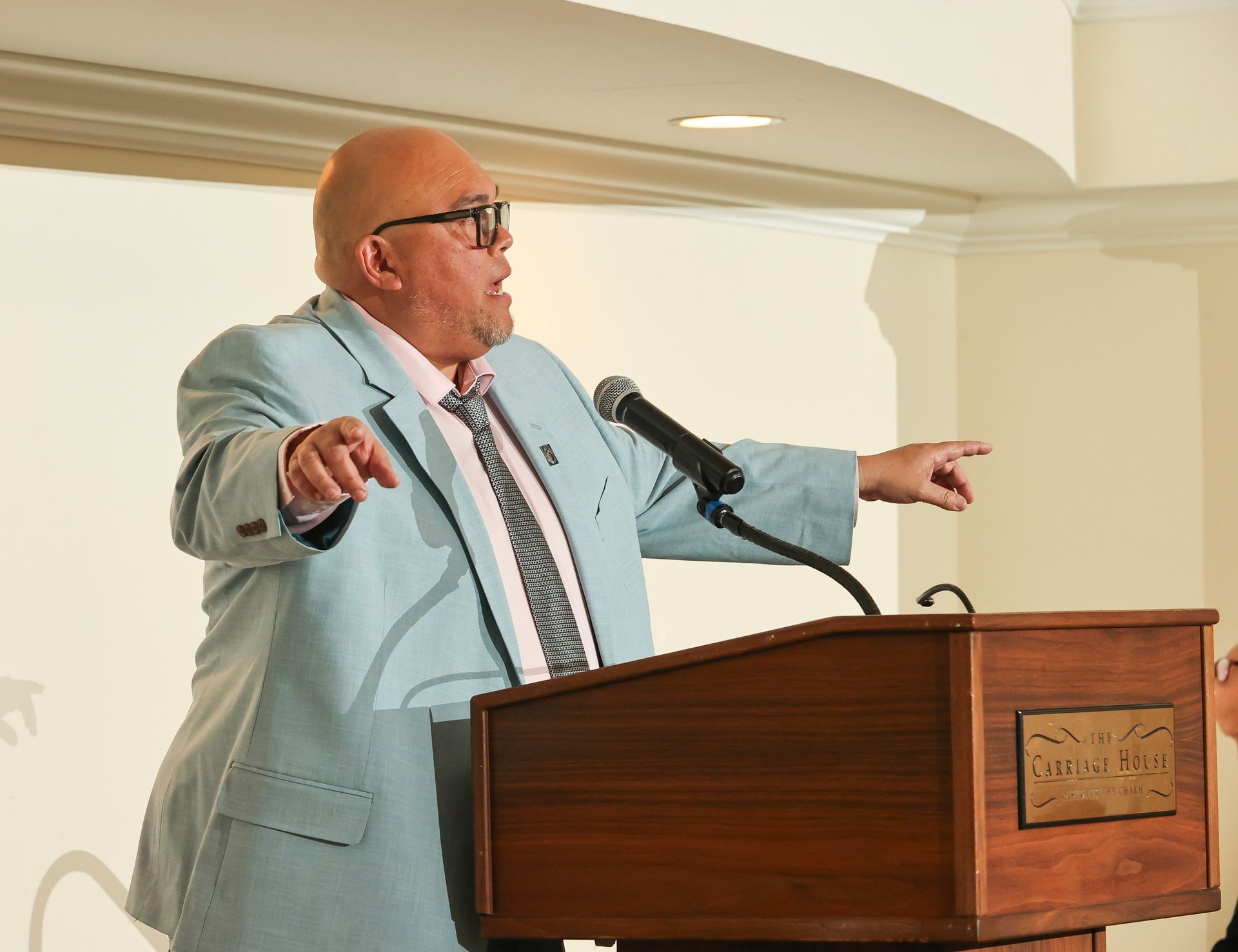 chuck donohue giving a speech in front of a podium
