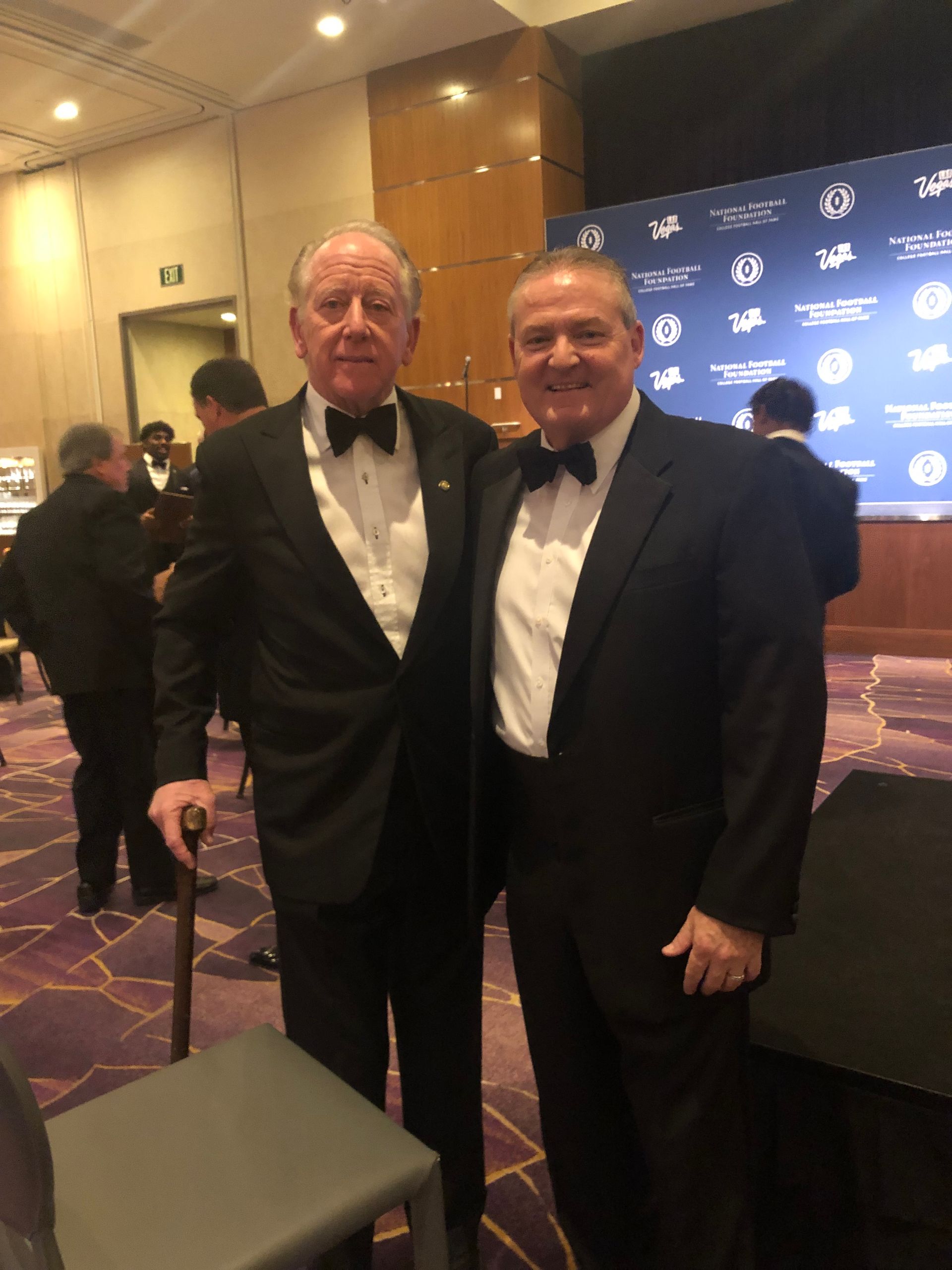 michael gatley president of NFFSJ standing with another man at 63 Annual National Football Foundation Awards Dinner