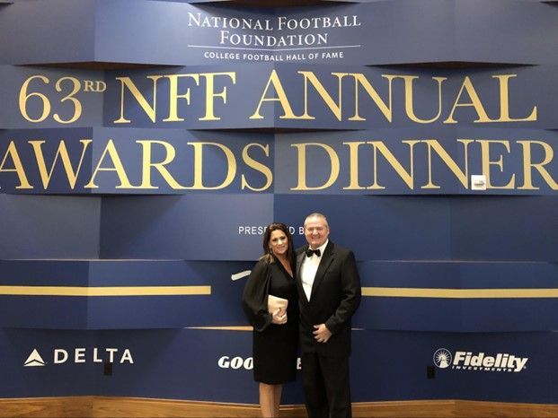 michael gatley and wife pose in front of a sign that says 63rd nff annual awards dinner