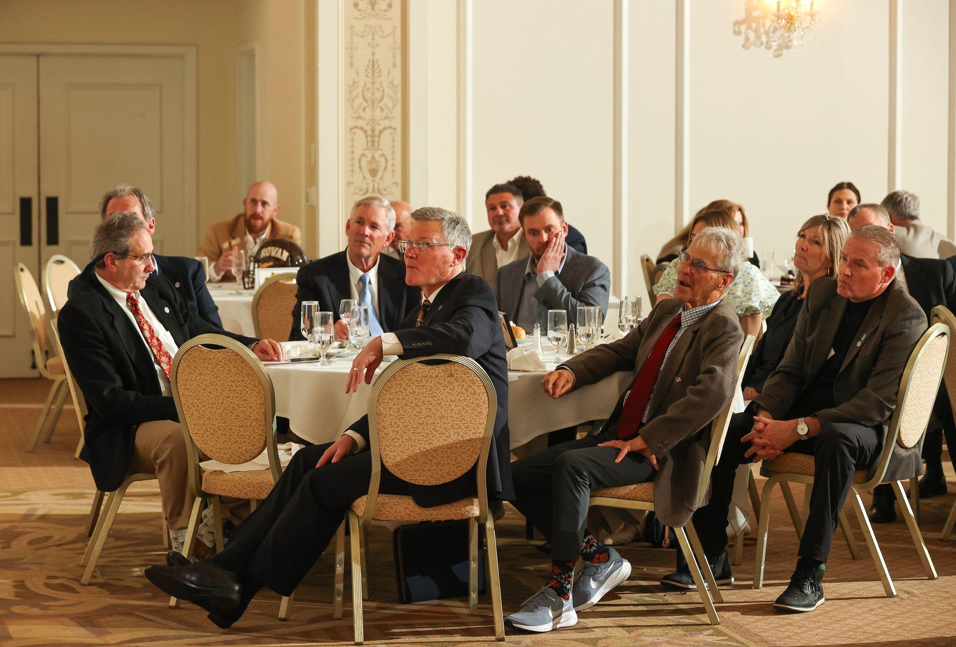 A group of people are sitting at tables in a room