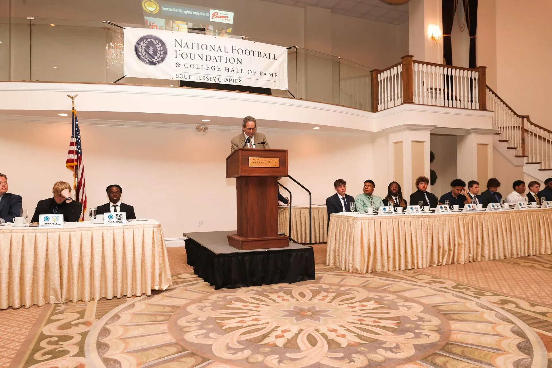 a man stands at a podium giving a speech at a conference