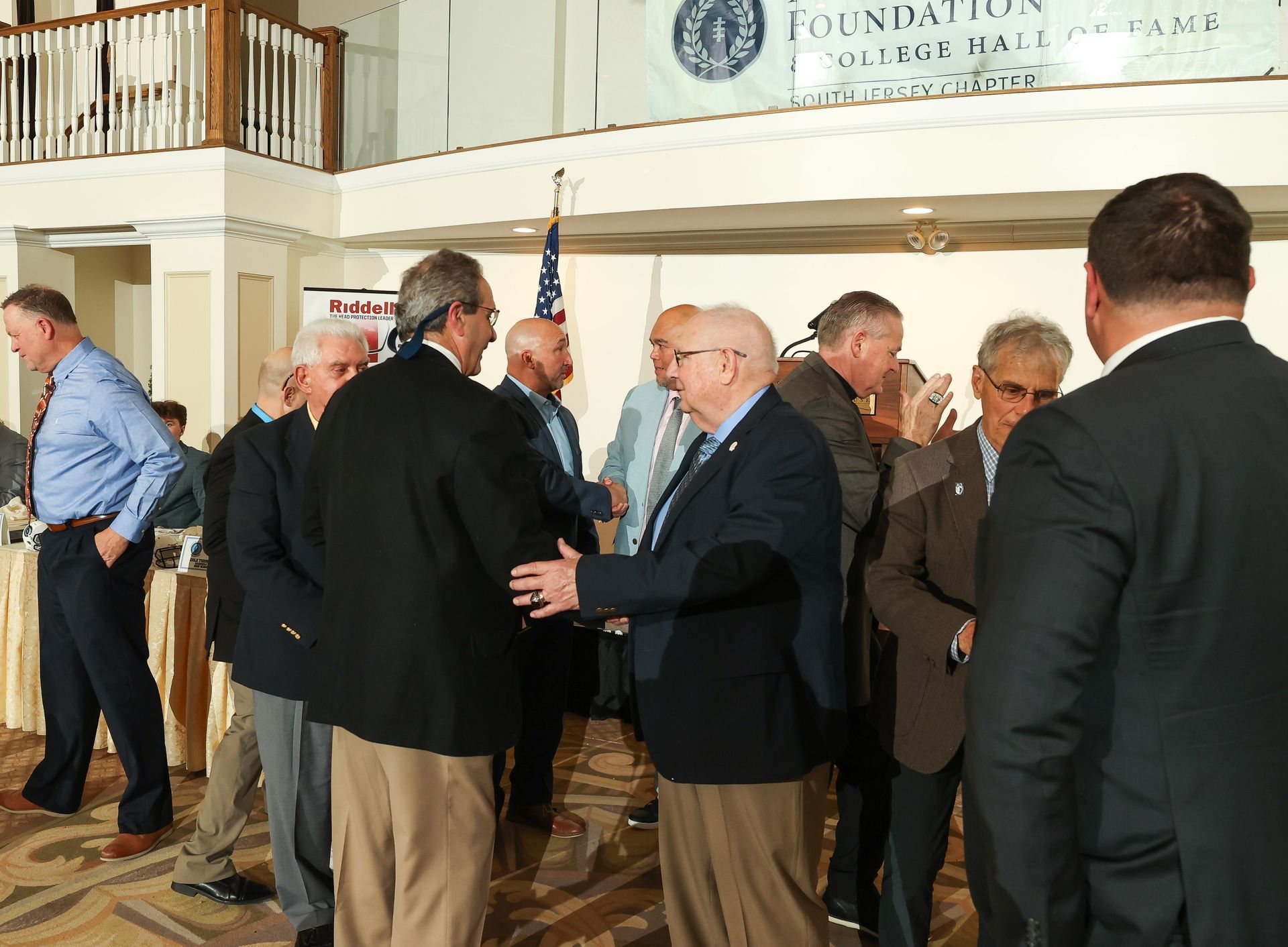 A group of men are standing in front of a sign that says foundation