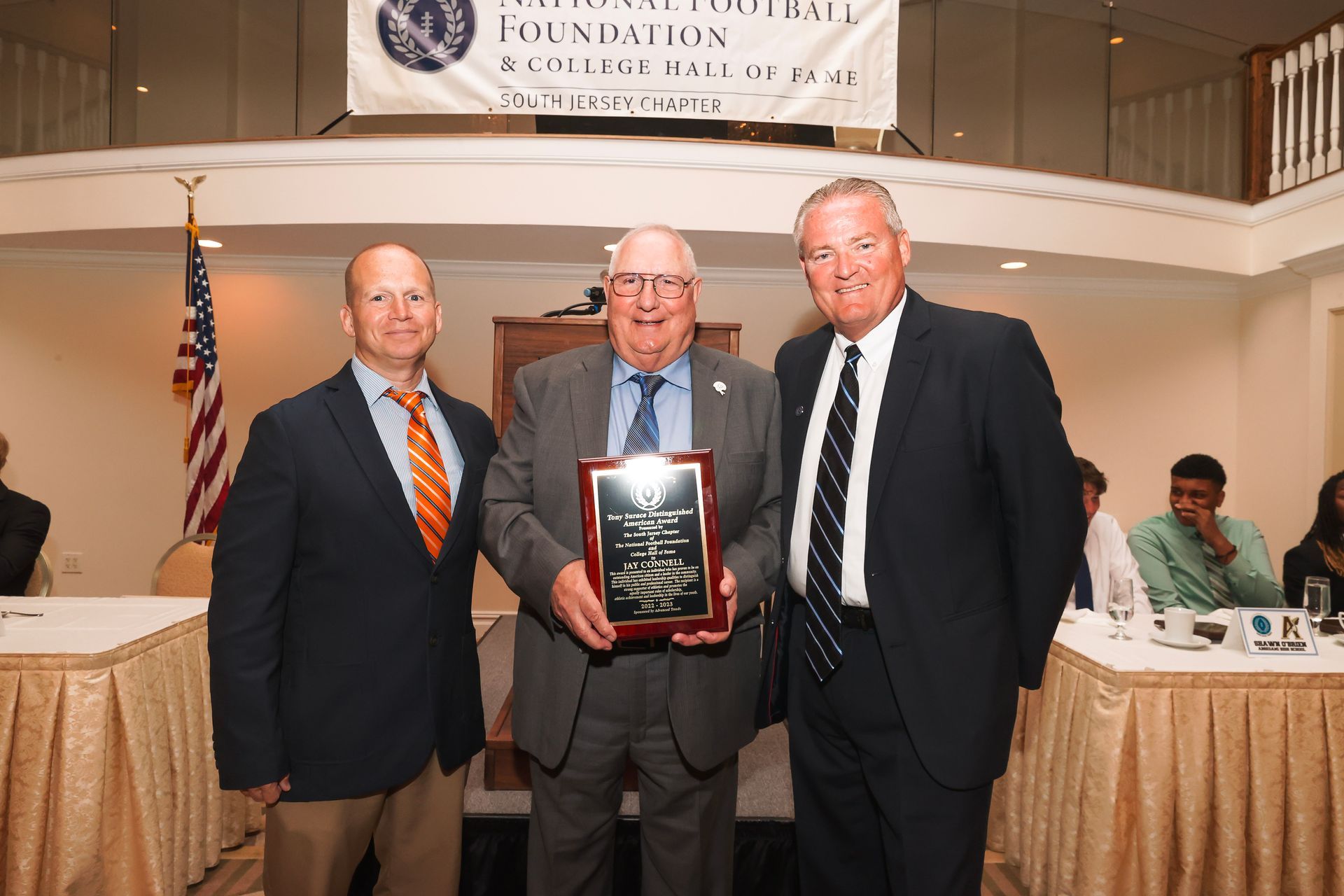 a man in a suit and tie is holding a plaque