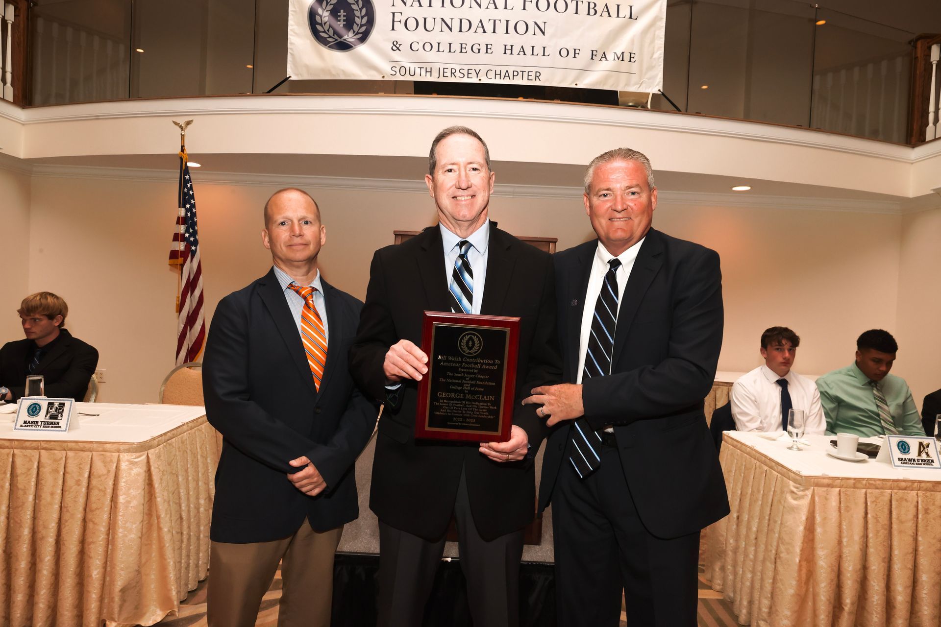three men standing in front of a sign that says foundation