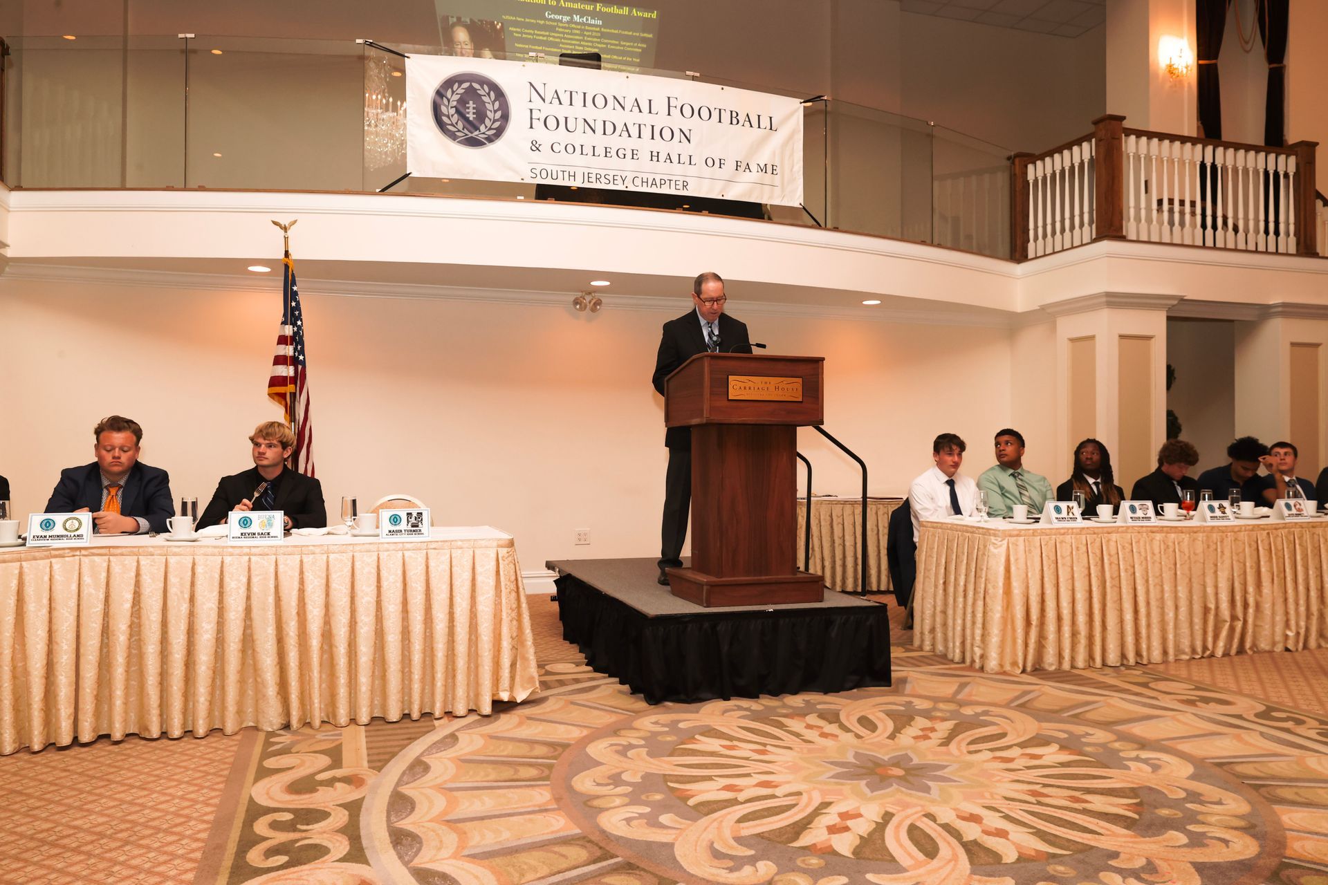 a man stands at a podium giving a speech at a conference