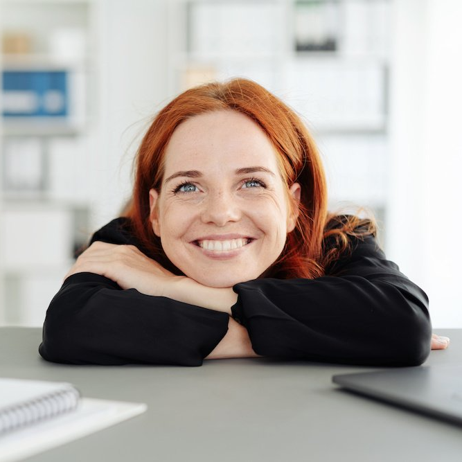 smiling woman head on crossed arms