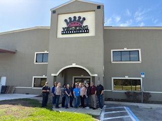 Group of people standing in front of a building with a 