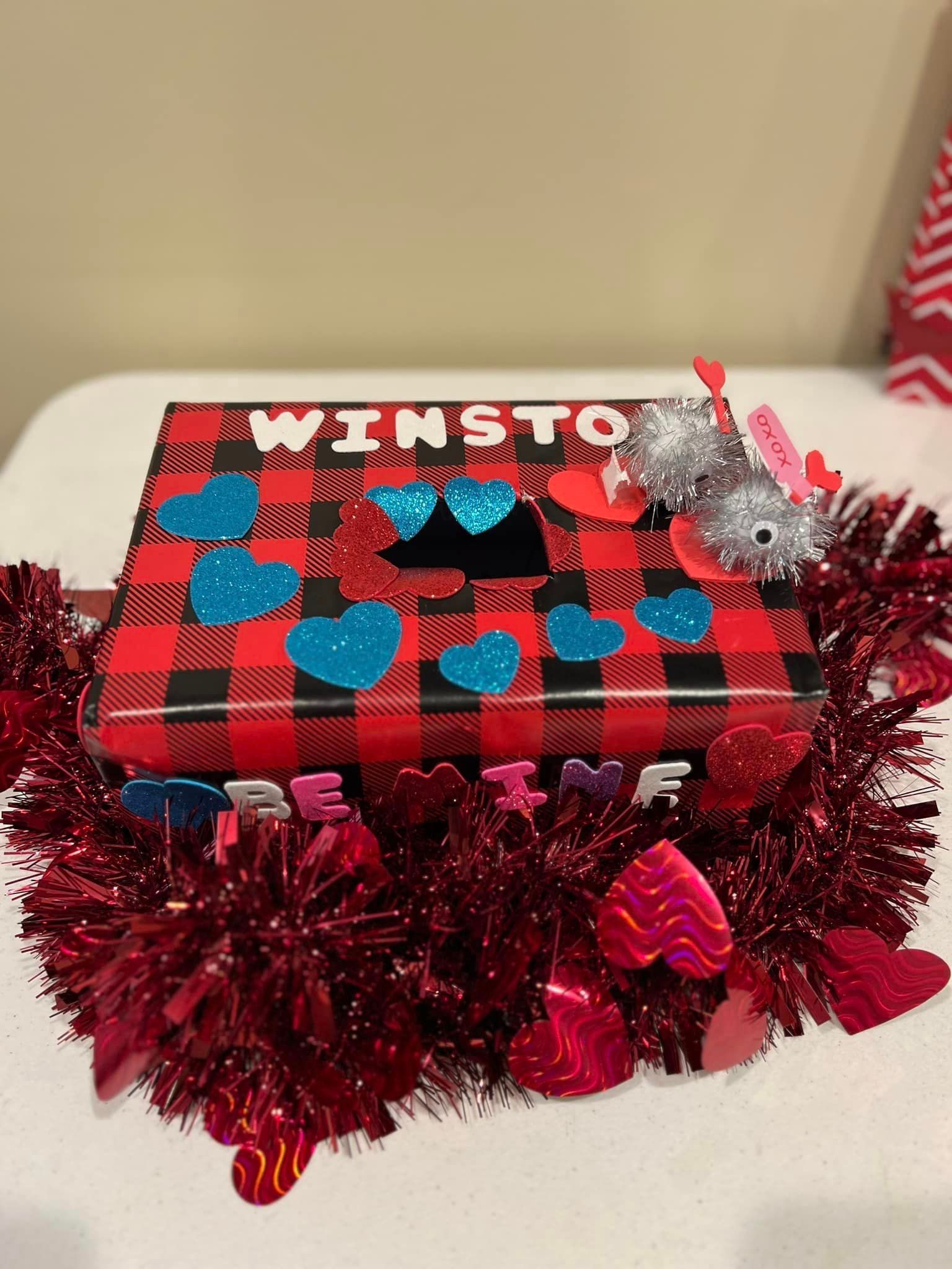 Valentine's Day mailbox decorated with a red and black plaid pattern, blue glitter hearts, and a silver glitter mouse.