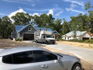 A moving truck is parked in front of a house.