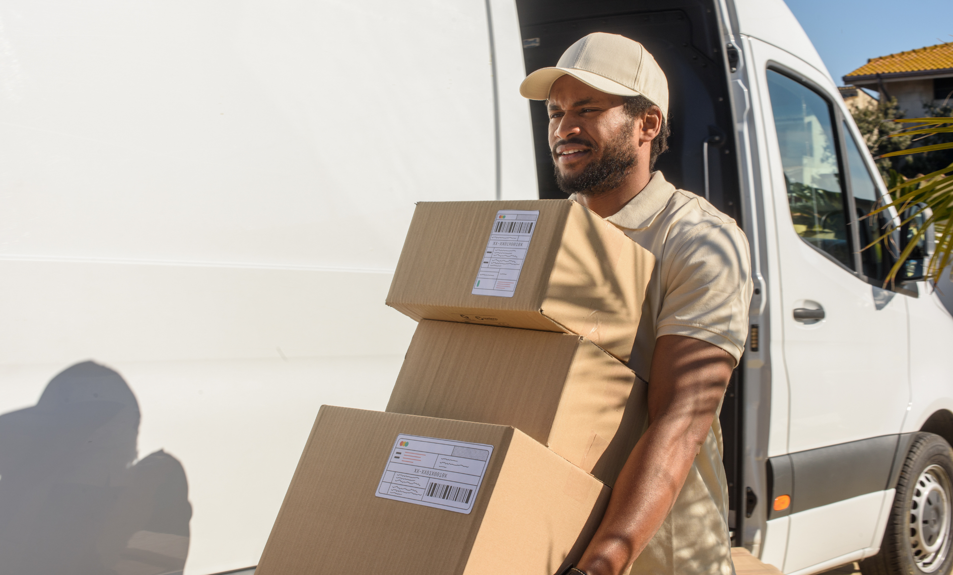 Two movers are carrying boxes out of a van.