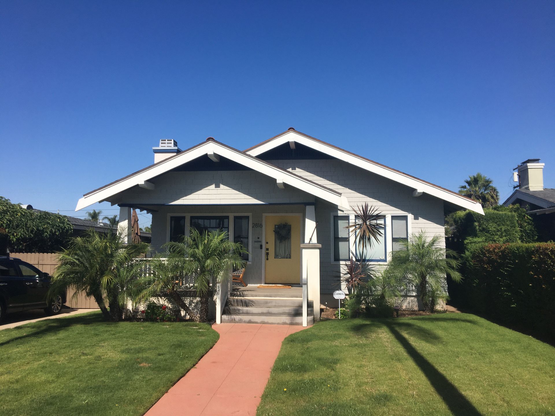 A house with a yellow door and a walkway leading to it