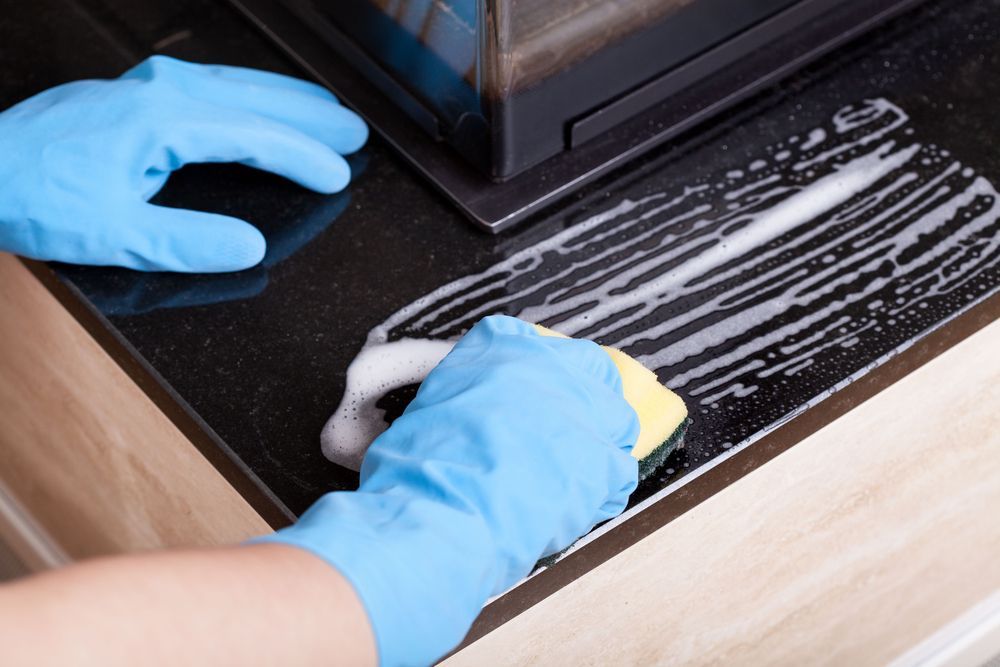 water-based degreaser being used to clean a kitchen countertop 