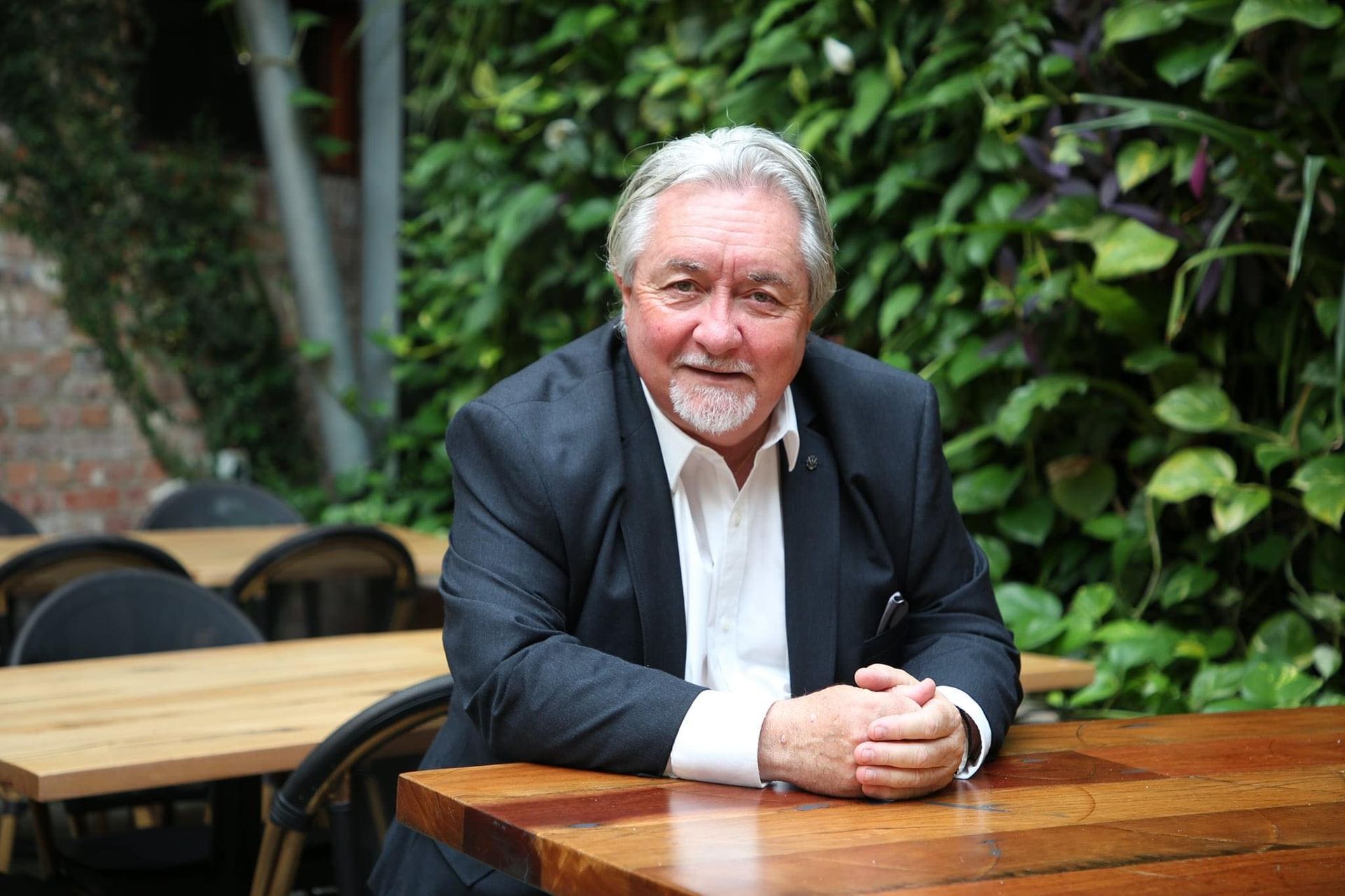 A Man Is Holding a Model House in His Hands — Maison Property Management in Mayfield, NSW