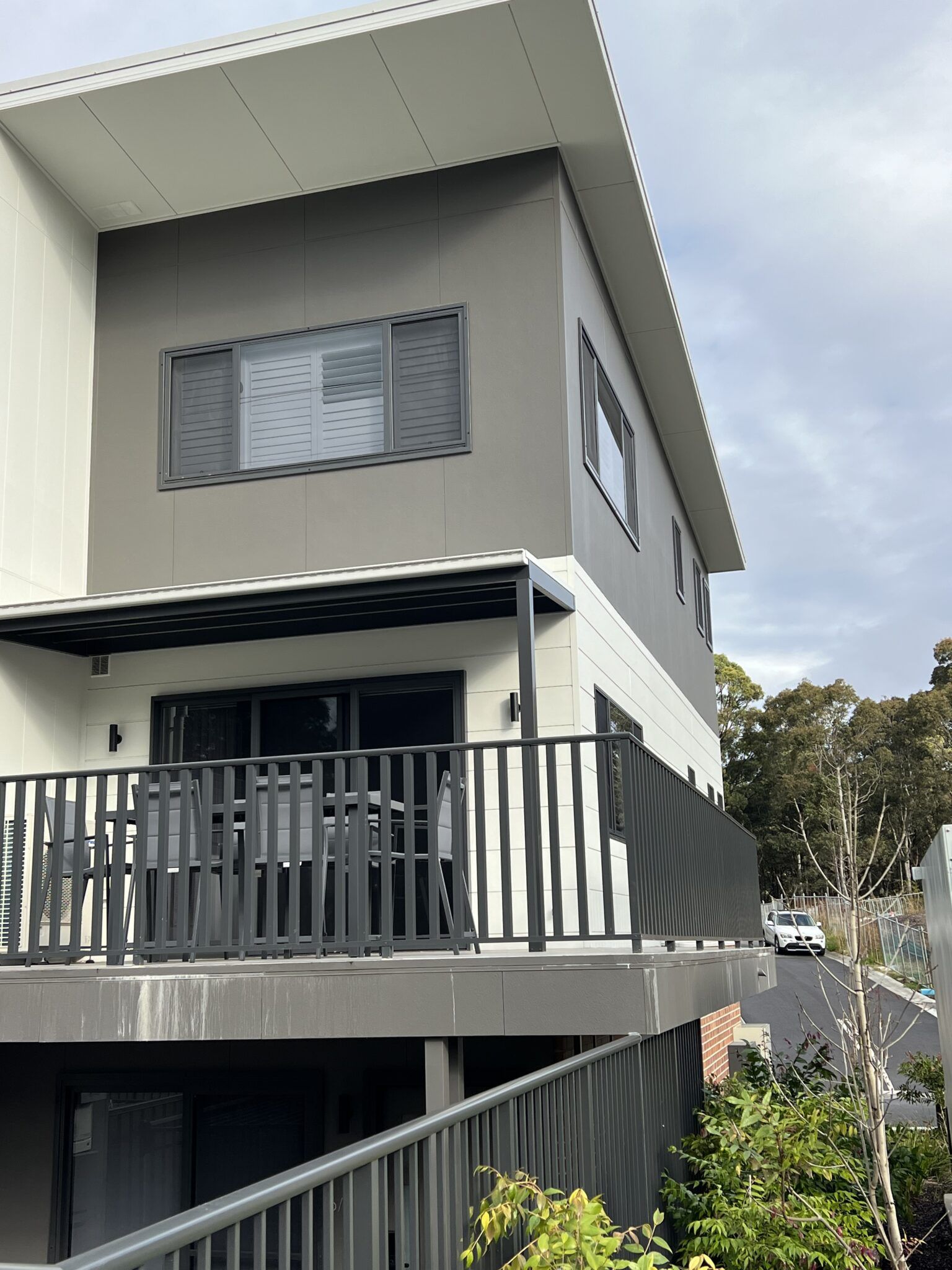 A Large House with a Balcony and a Fence around it