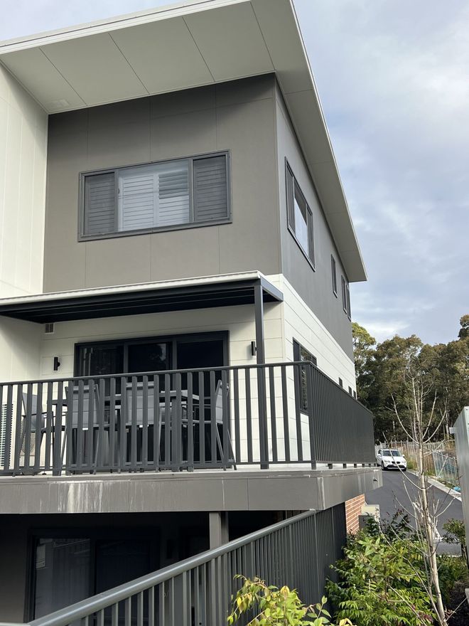 A Large House with a Balcony and a Fence around it