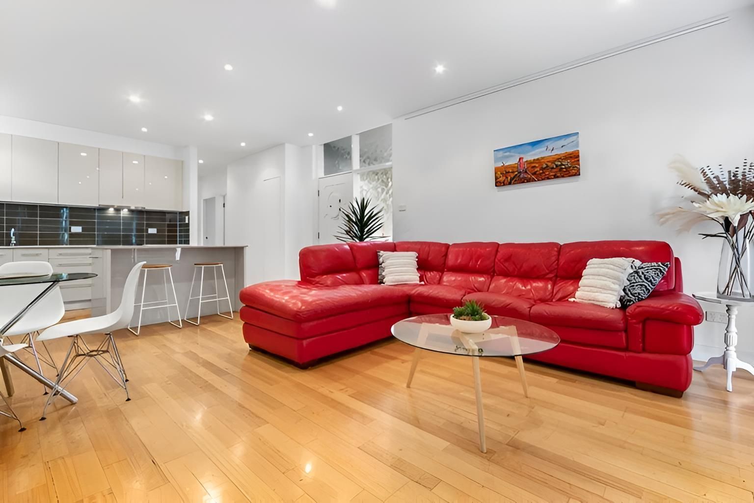 Living Room With a Red Sectional Couch — Maison Property Management in Mayfield, NSW