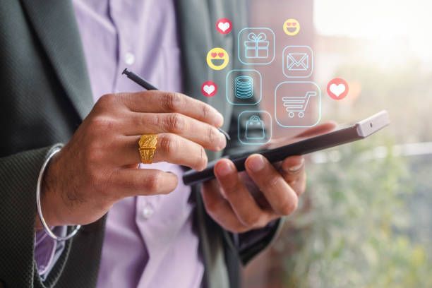 A man in a suit is holding a cell phone in his hands.