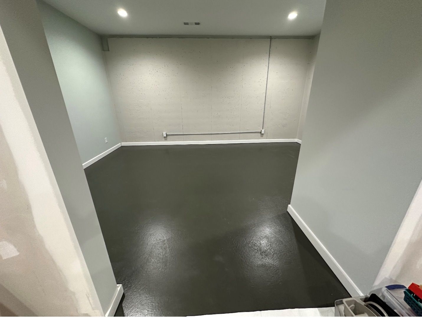 A room with a black floor and white walls.