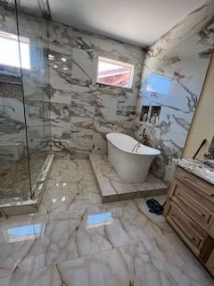 A bathroom with a bathtub and a walk in shower.