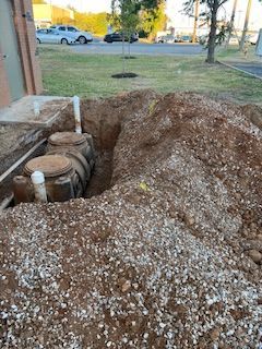 A septic tank is being installed in a hole in the ground.