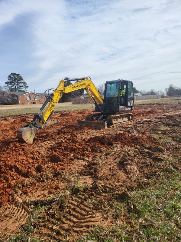 Two people installing guttering with a truck in a sunny outdoor setting.