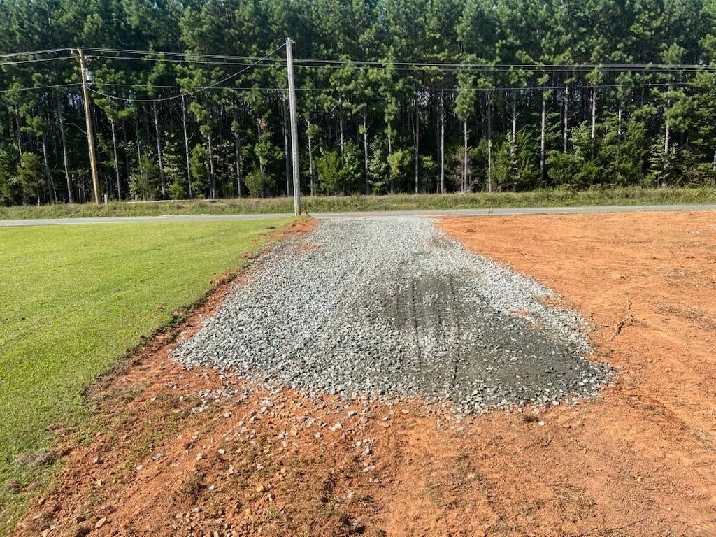 Two people installing guttering with a truck in a sunny outdoor setting.