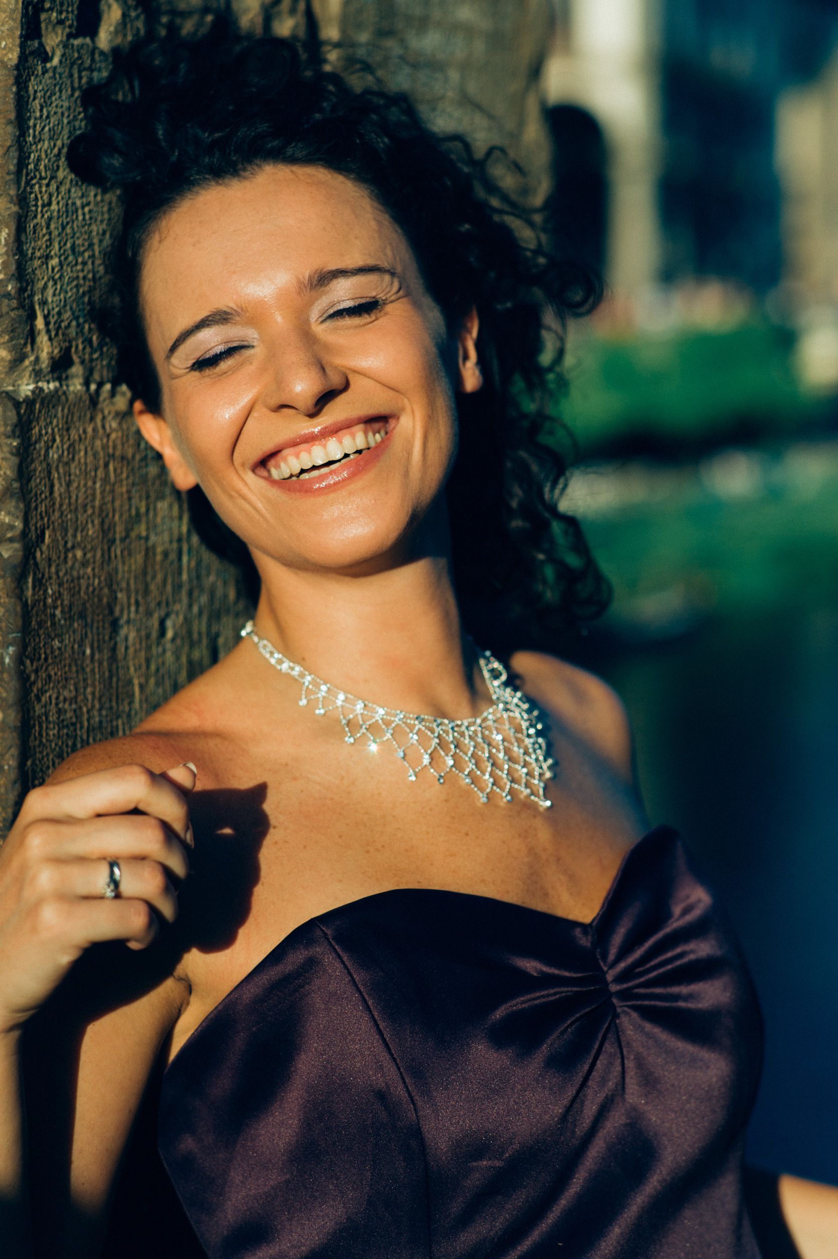 Group of diverse professionals smiling in an office hallway.