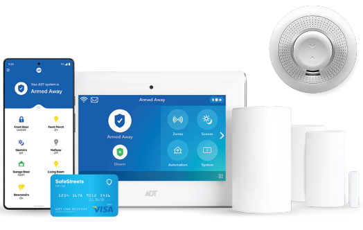 Family of four smiling, sitting on a couch with a cardboard house above them in a living room.