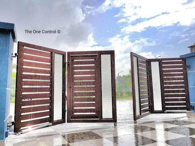 Modern brown and frosted-glass folding autogates Malaysia homeowners use for space-saving driveways,