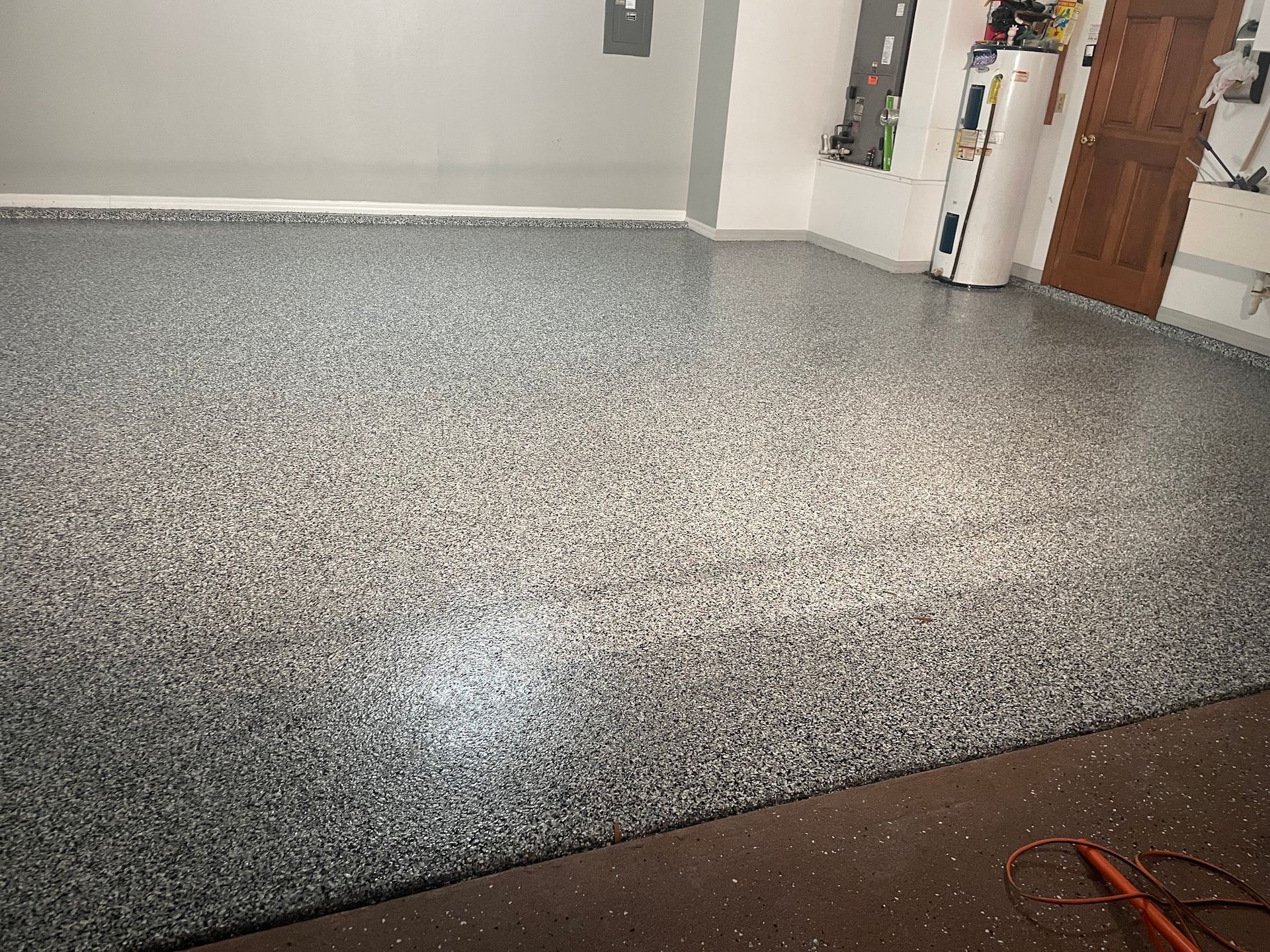 A garage with a concrete floor and a door.