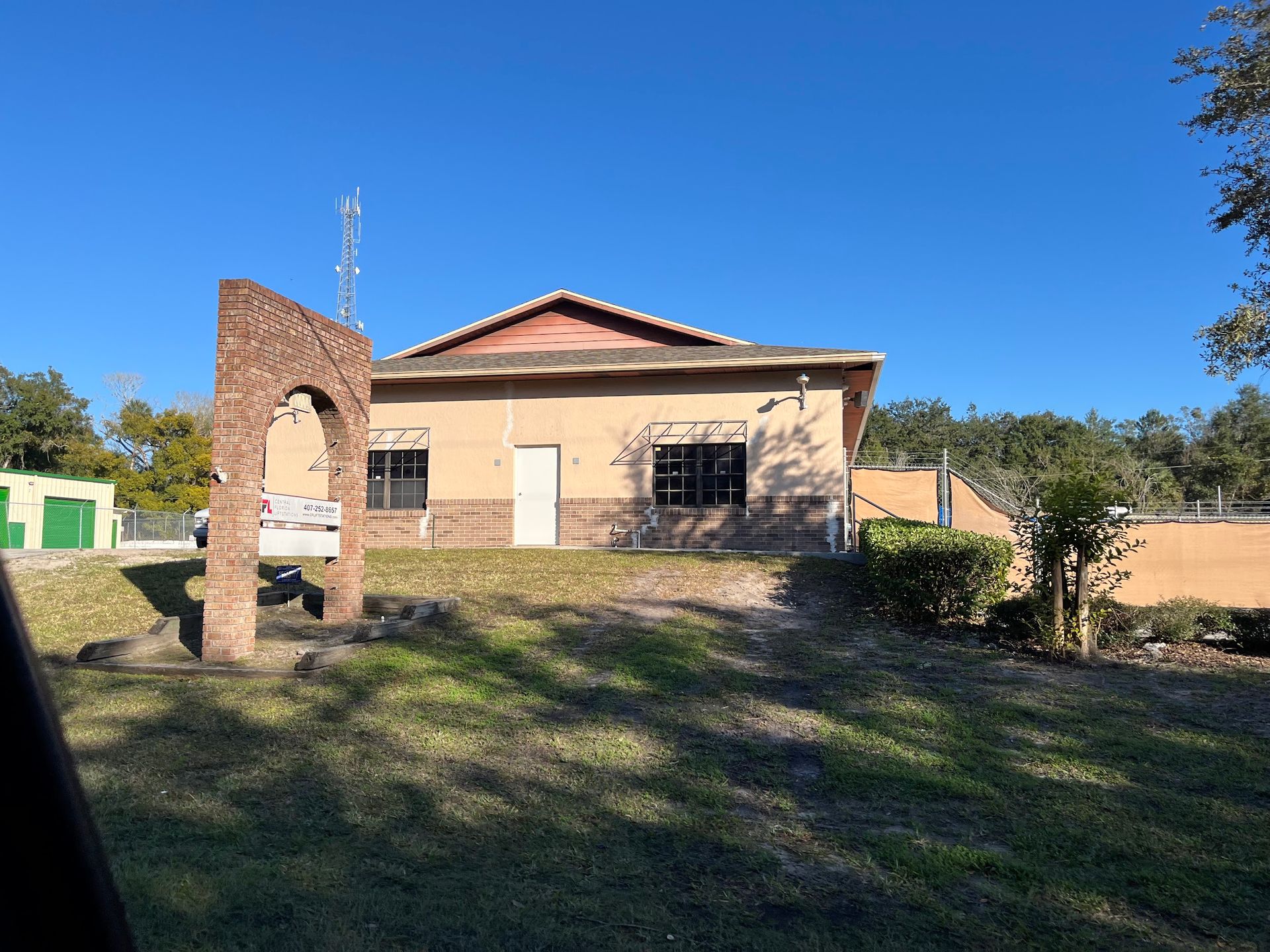 A large house with a brick archway in front of it