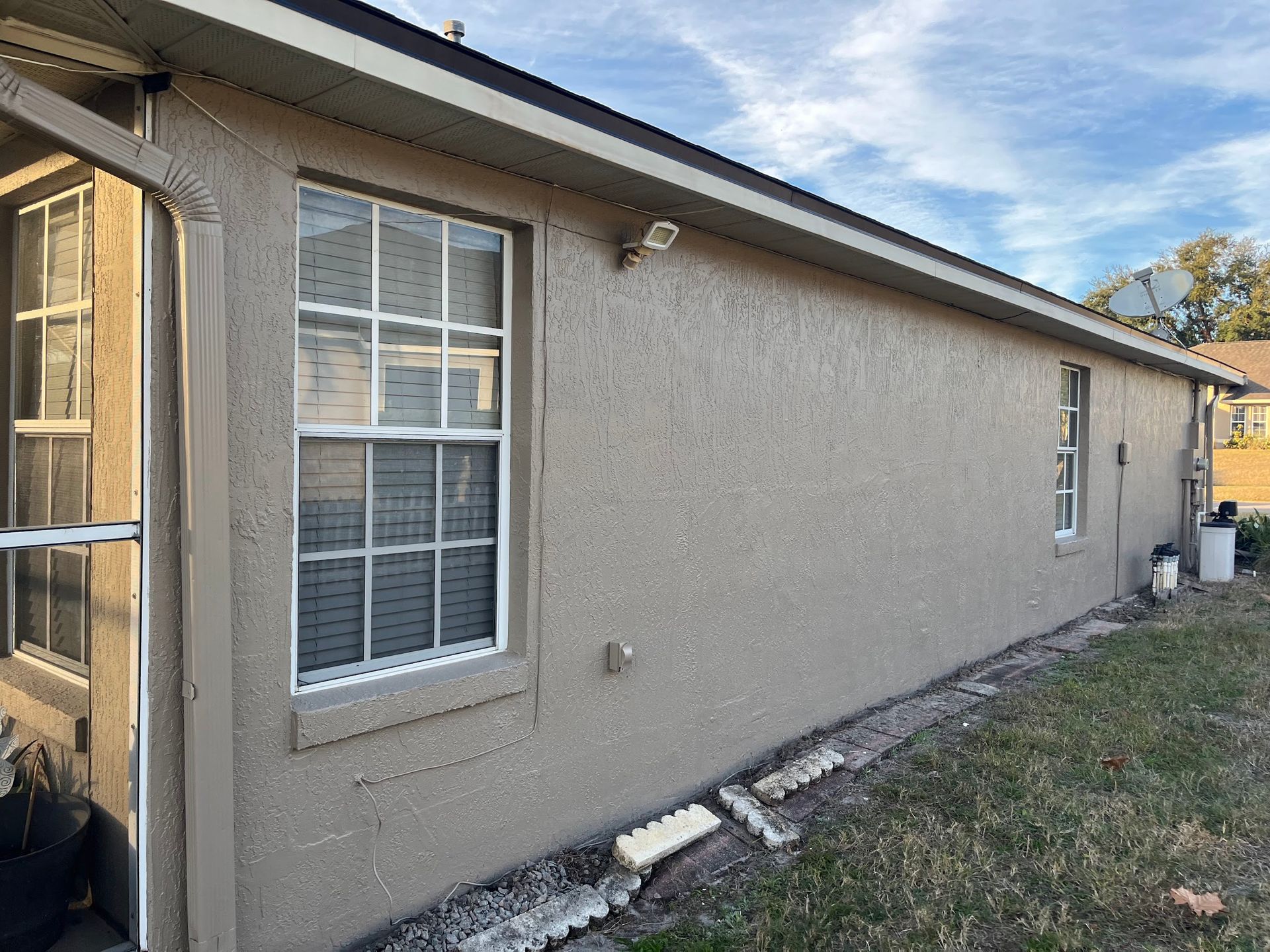 A house with a lot of windows on the side of it.