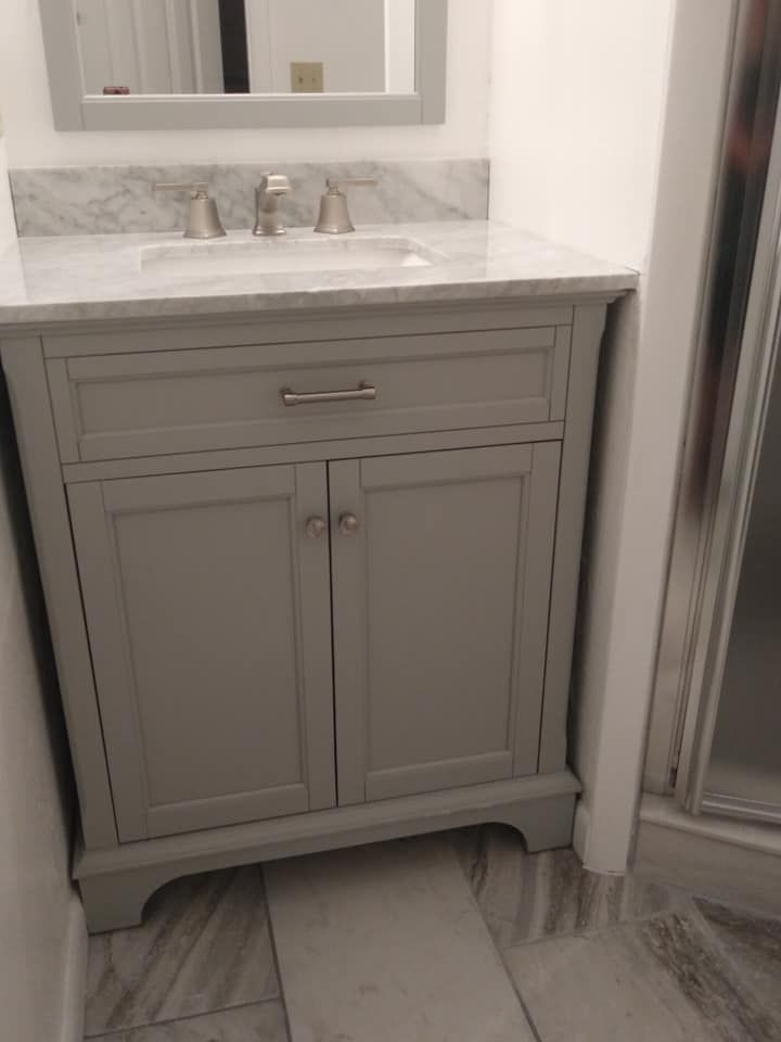 A bathroom vanity with a sink and a mirror.