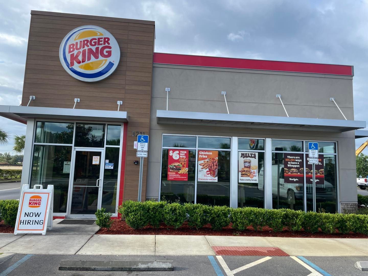 A burger king restaurant with a handicapped parking spot in front of it